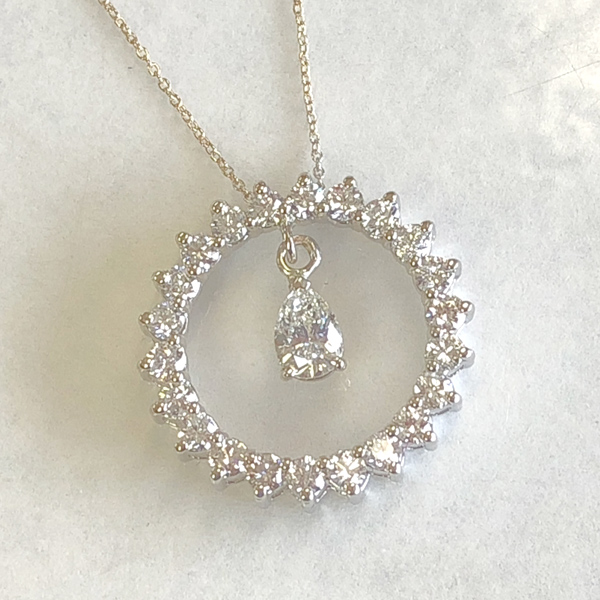 altered pendant has pear-shaped diamond hanging freely from the eternity circle