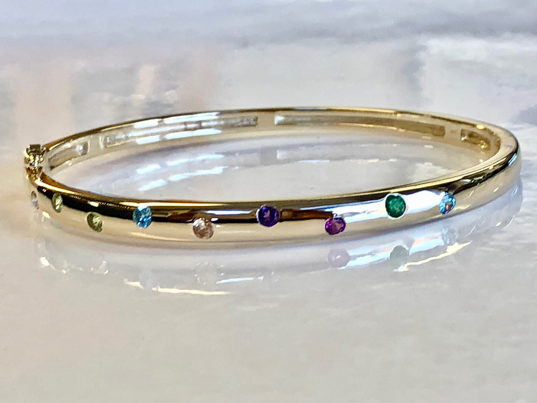gold bangle with gemstones in a zigzag pattern (as life is)