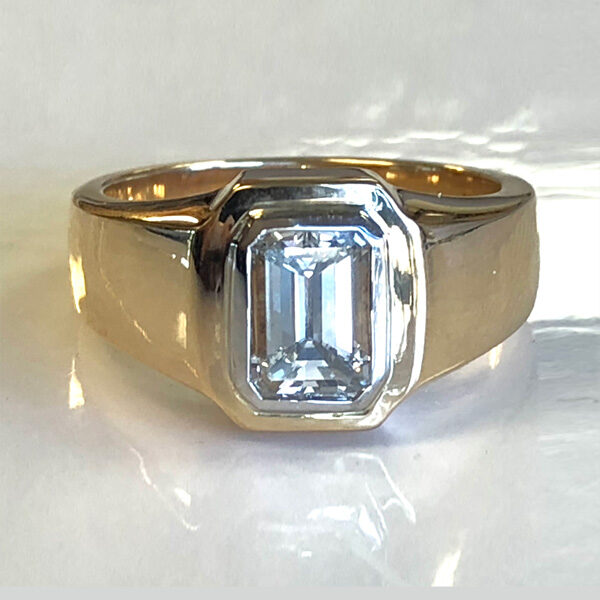 mans 14k gold ring has emerald cut diamond in a platinum bezel