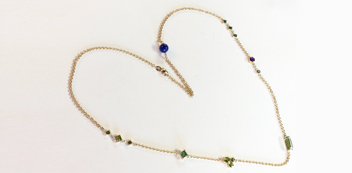necklace with gems said to have great powers lapis lazuli, emerald, aquamarine, and peridot