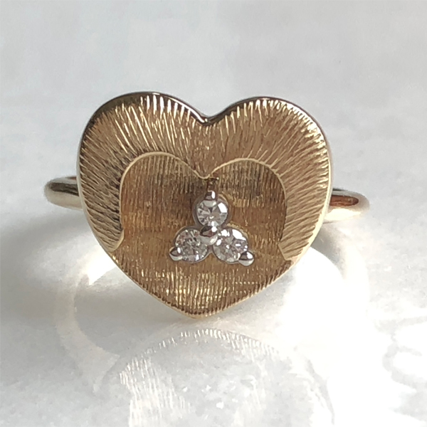 gold heart ring with three small diamonds