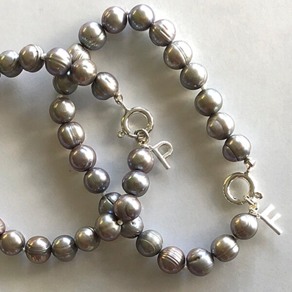 each silver gray pearl bracelet has silver initial