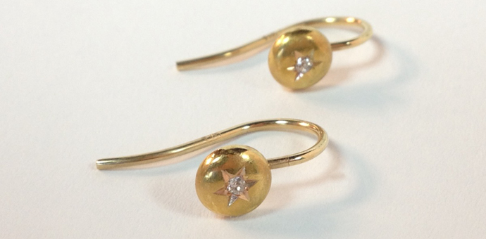 front view of gold star diamond earrings made from tuxedo buttons