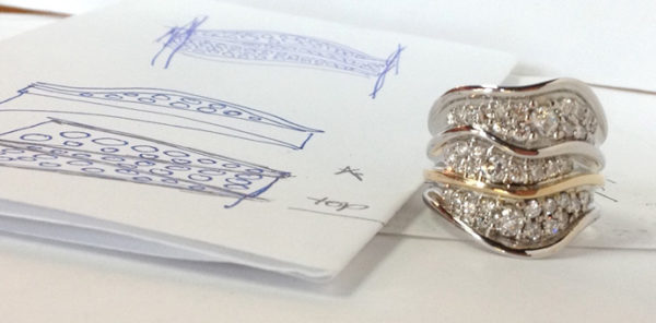 Finished wavey ring with pave diamonds next to the sketch drawing